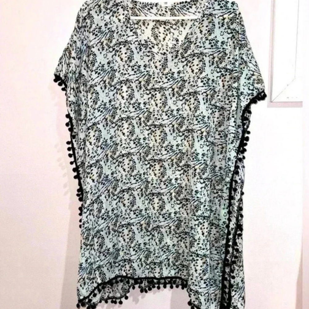 West Loop Animal Print one-size swimsuit cover-up with a black ball fringe trim